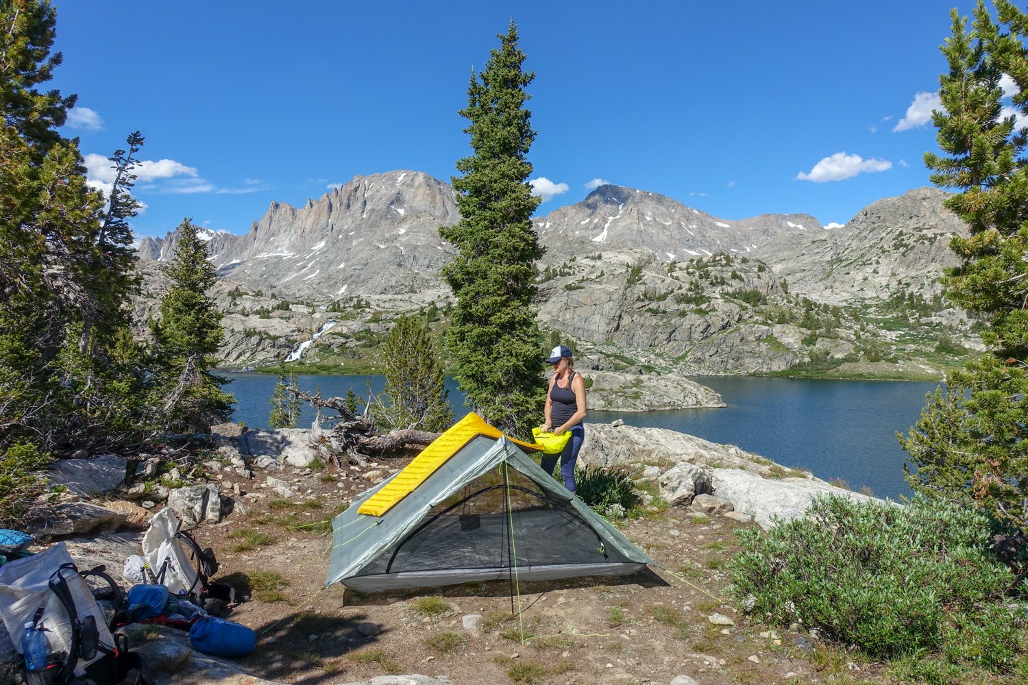 Hiker blowing up the nemo tensor sleeping pad in the wind river raange