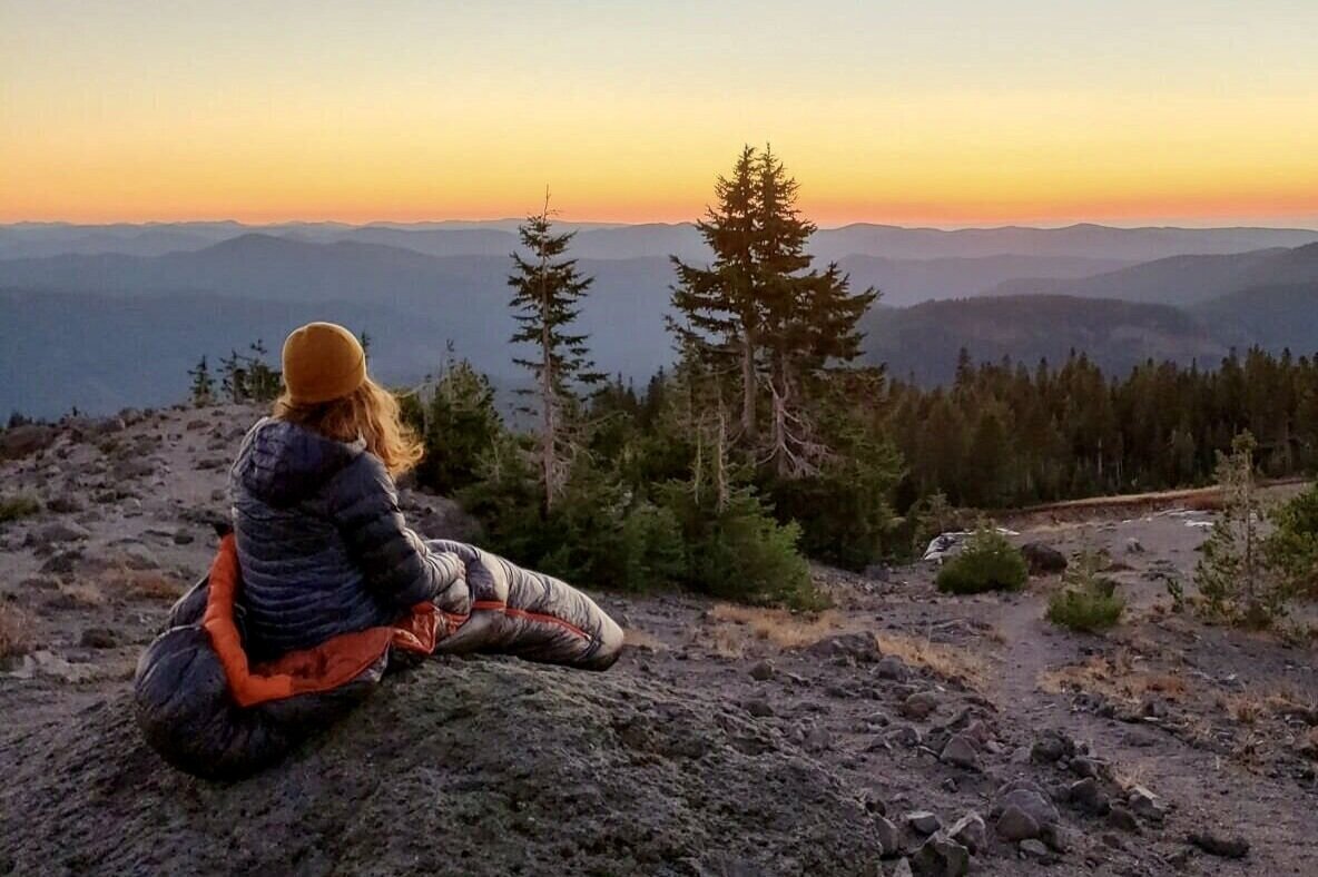 backpacker watching the sunset in the rei magma sleeping bag