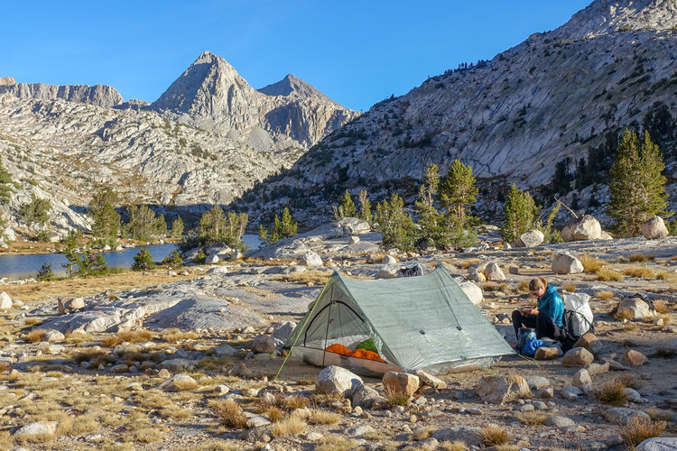 A+hiker+sitting+next+to+the+zpacks+triplex+ultralight+backpacking+tent+with+mountains+in+the+background.jpg