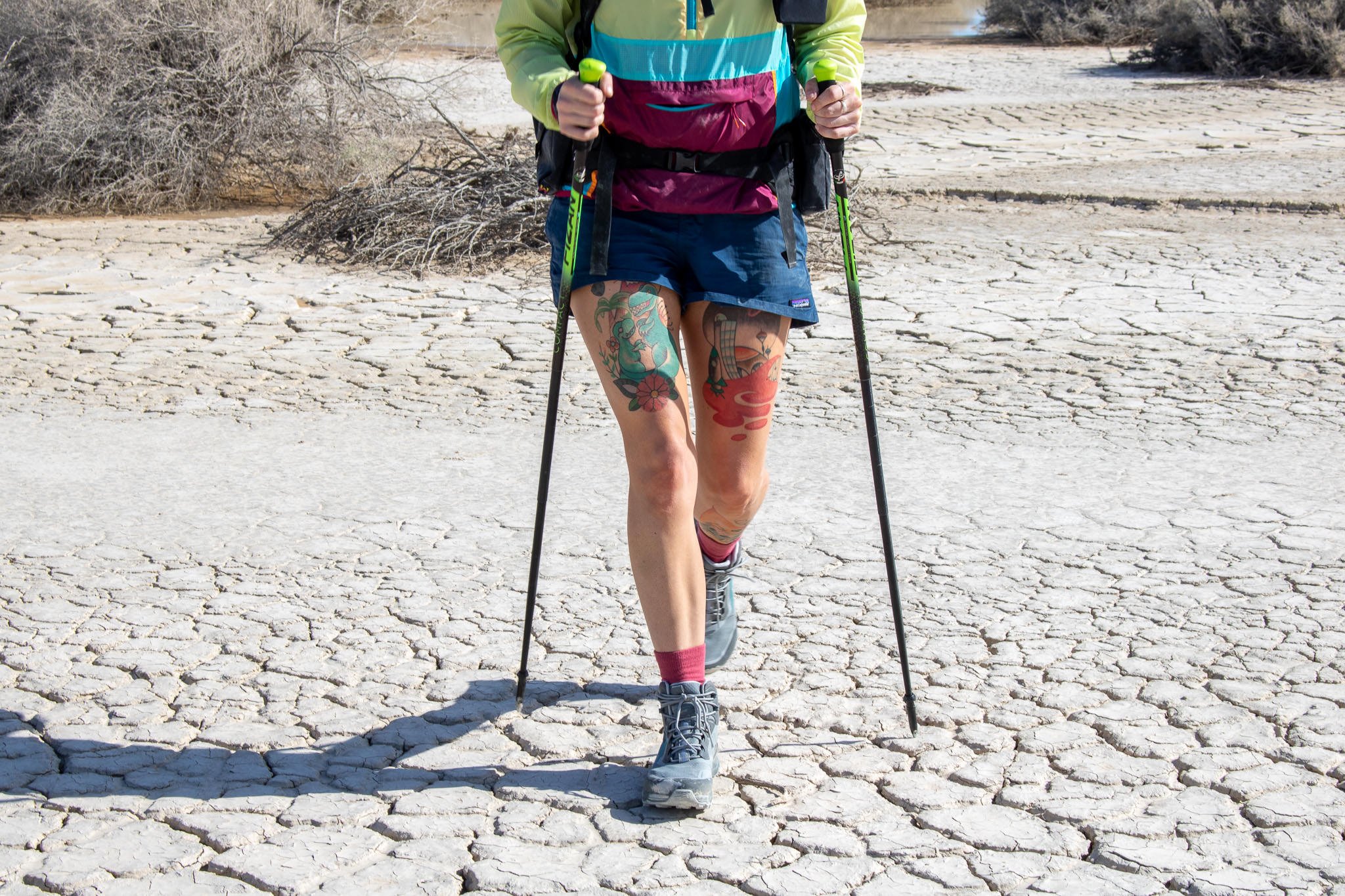 A hiker walking through the desert with the Fizan Compact 3 trekking poles