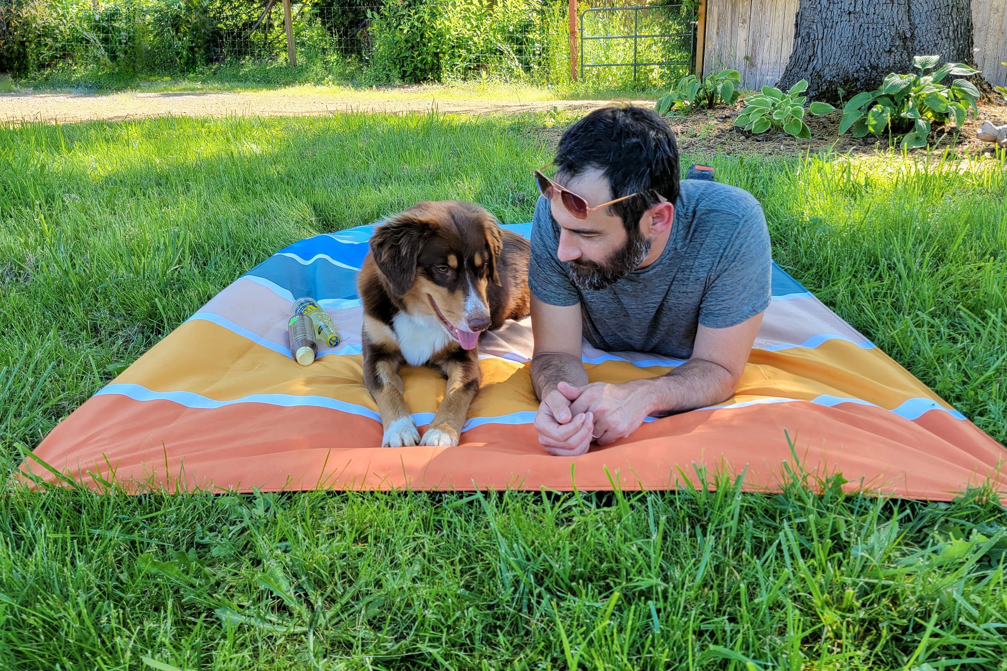 A man and his dog on the Nomadix Festival Blanket