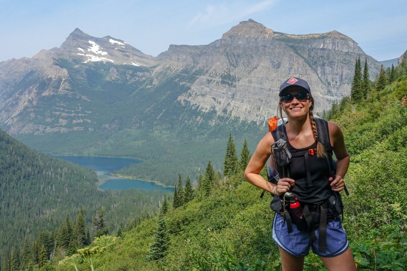 A backpacker wearing the Nike Dri-FIT Tempo shorts in Glacier National Park