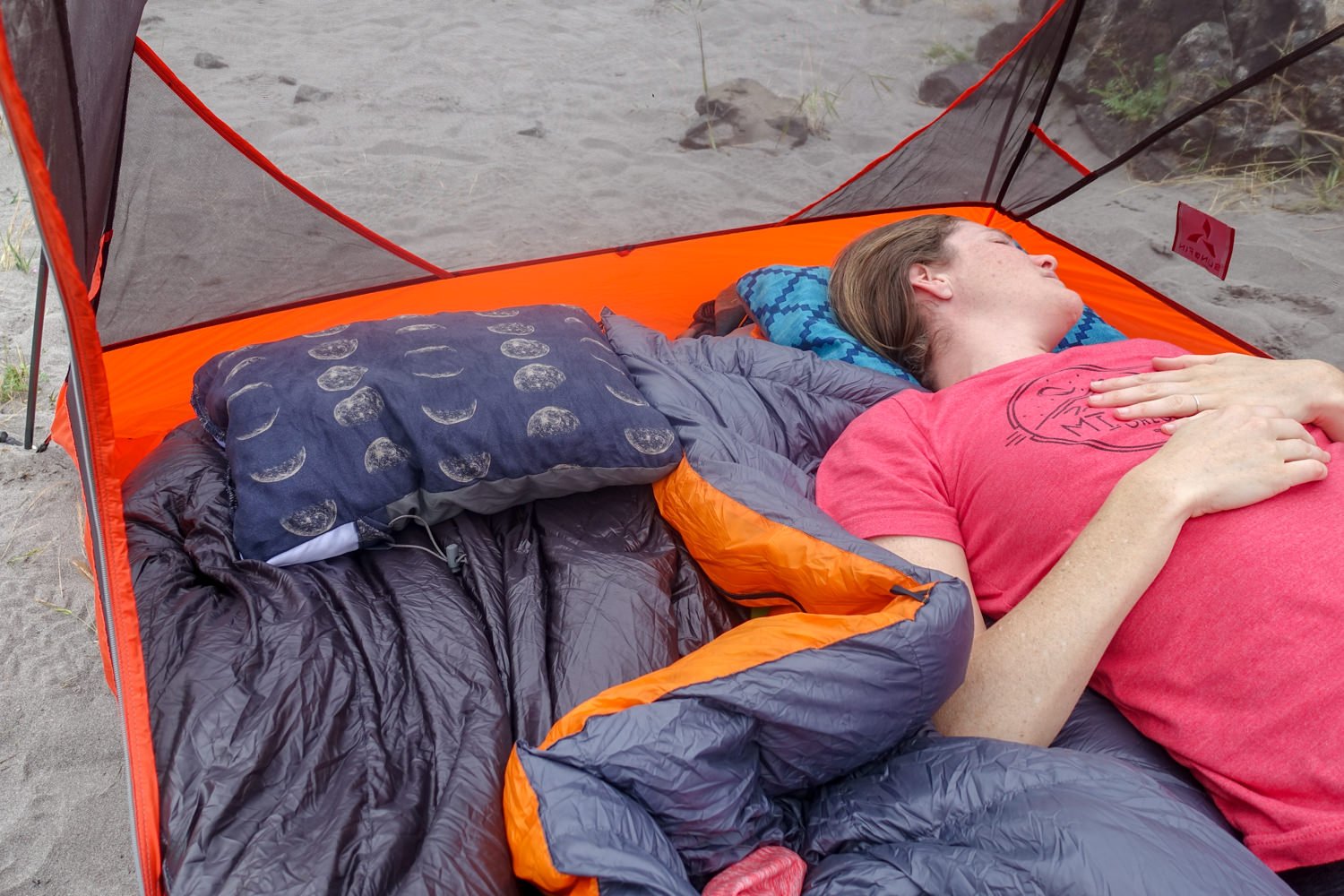 A camper sleeping on the Therm-a-Rest Compressible Pillow