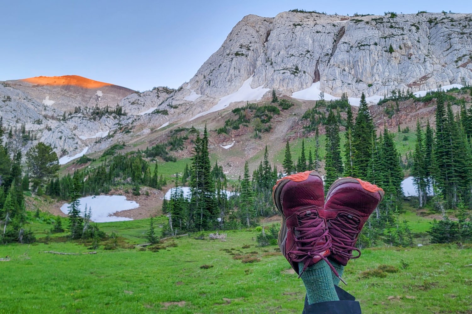 Closeup of a hiker's feet in the Topo Ultraventure 2 Hiking Shoes in front of a granite mountain