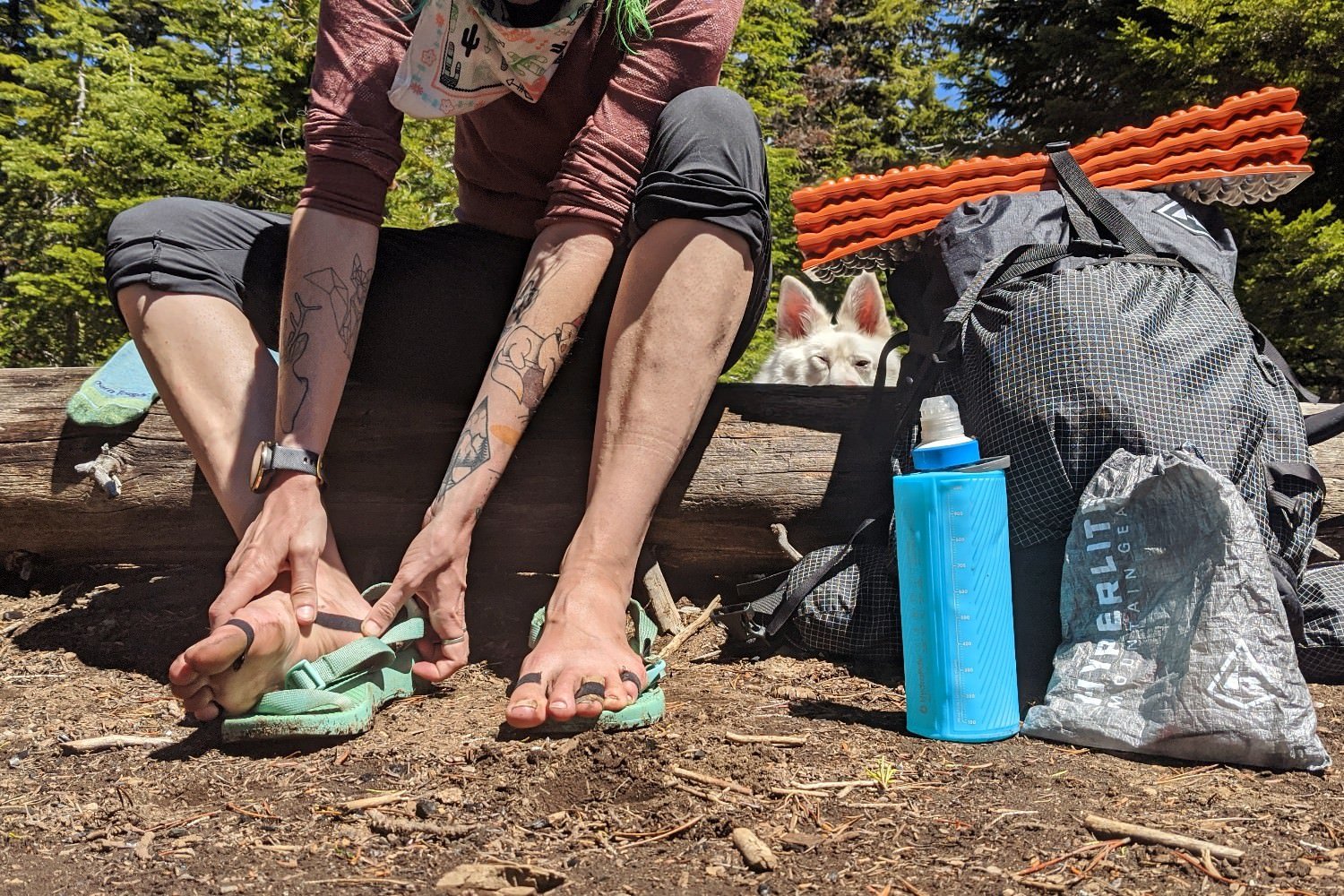 A hiker taping her feet