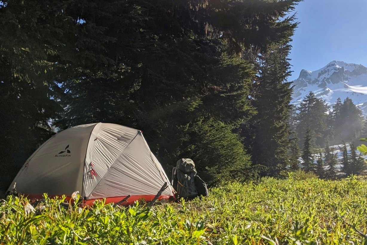 The Slingfin Portal tent set up in front of a mountain view