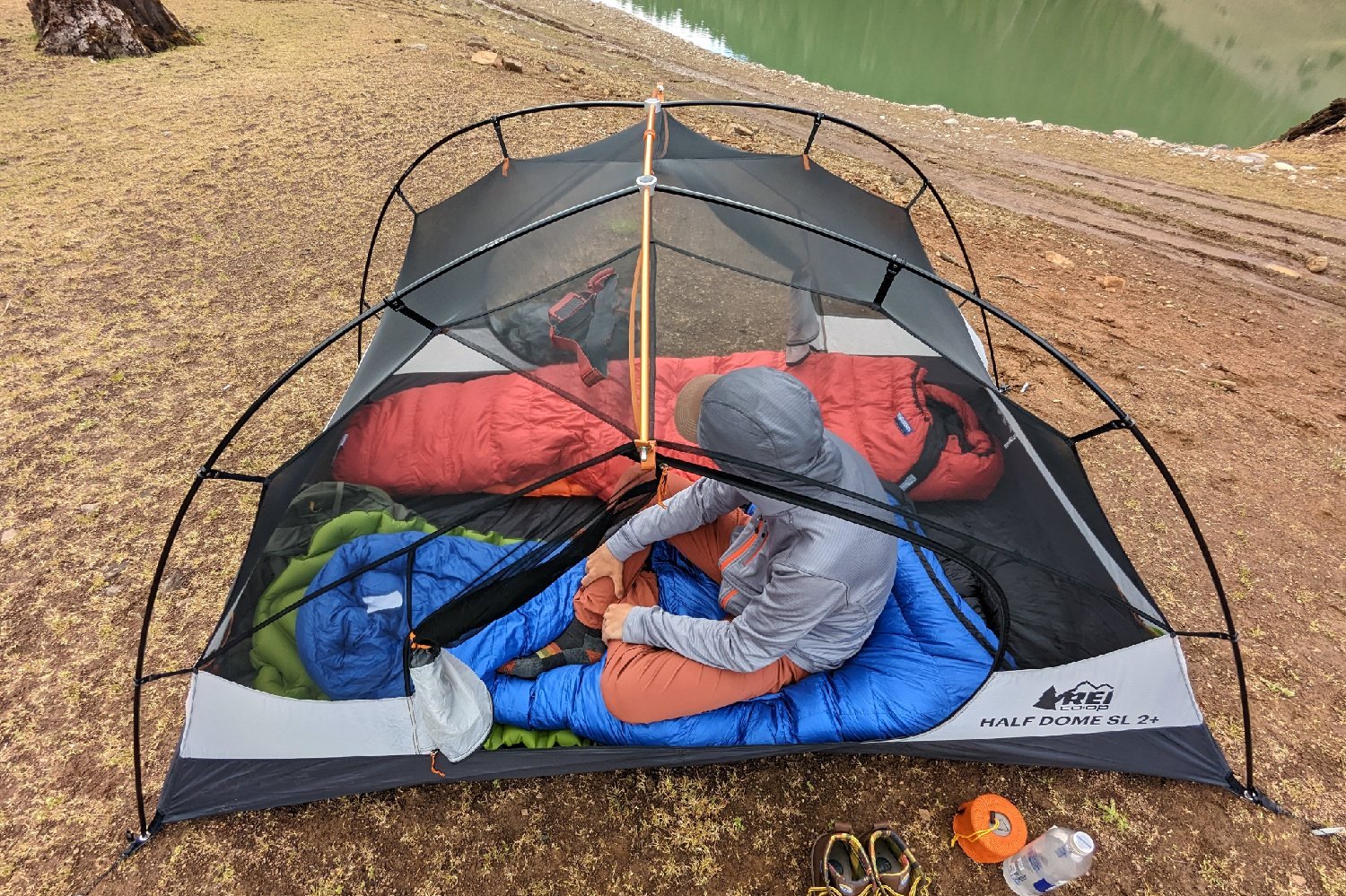 A view from above showing the headroom in the Half Dome SL 2 - there's a hiker sitting inside with some sleeping bags and other gear