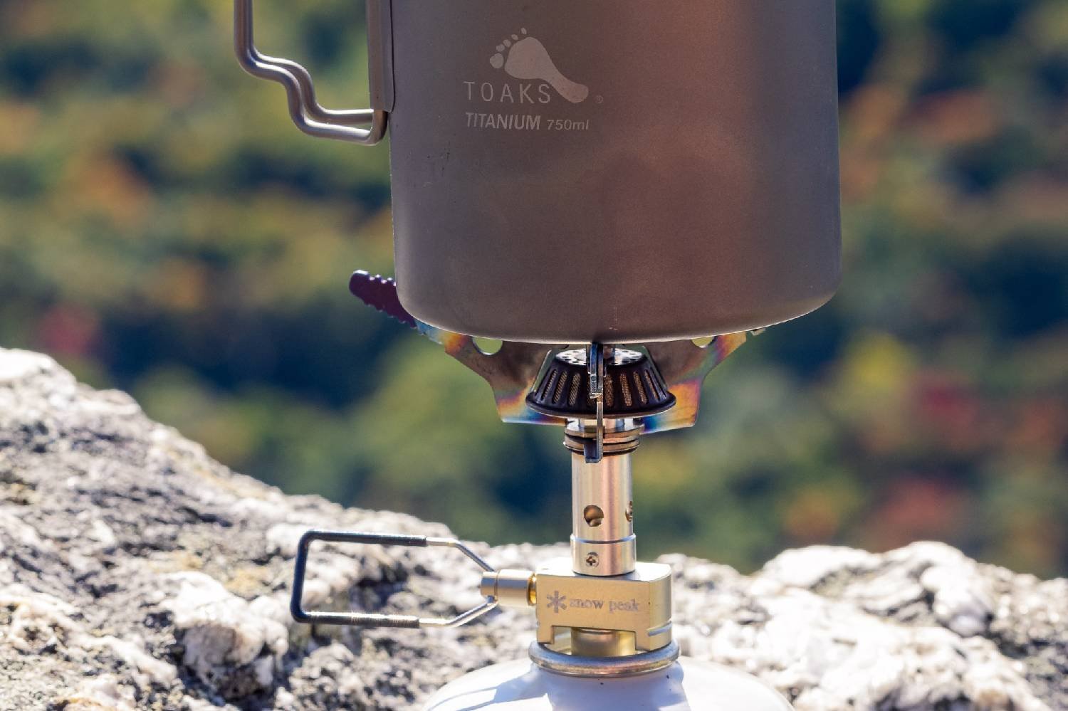 A close up view of the Snow Peak Litemax stove with a Toaks pot on top