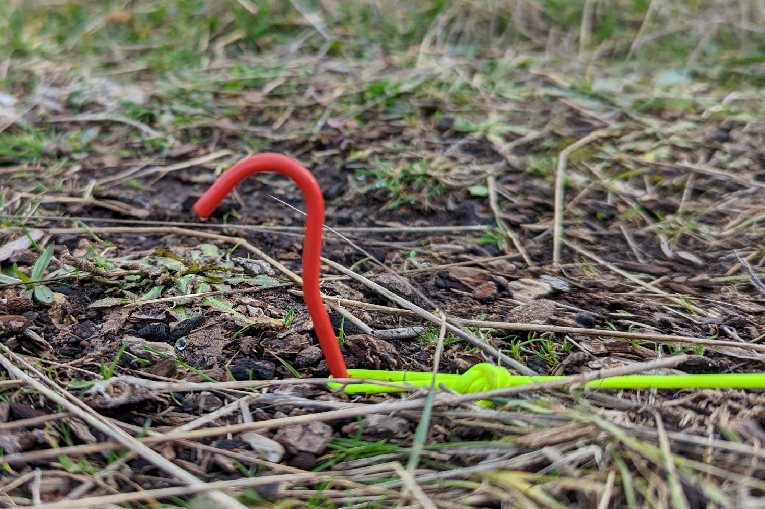 A vargo tent stake with some yellow ZPacks ZLine attached