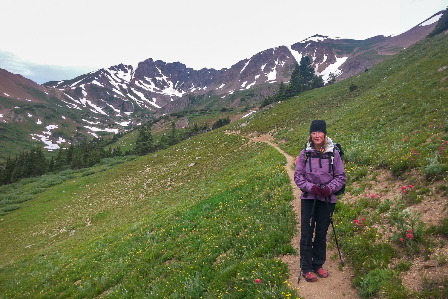 A backpacker wearing the Patagonia Torrentshell Jacket