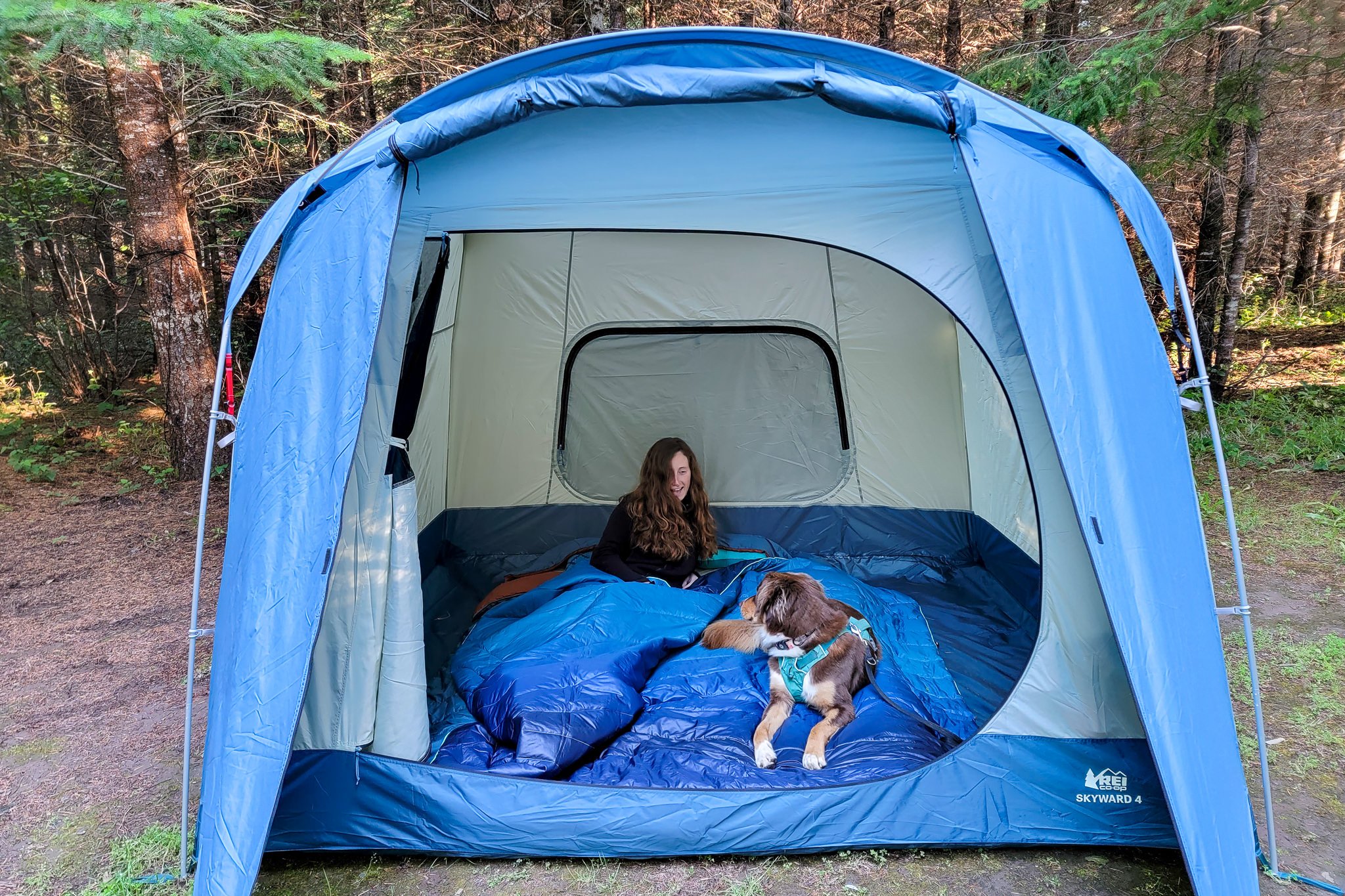 A woman and her dog in the REI Skyward 4 Tent