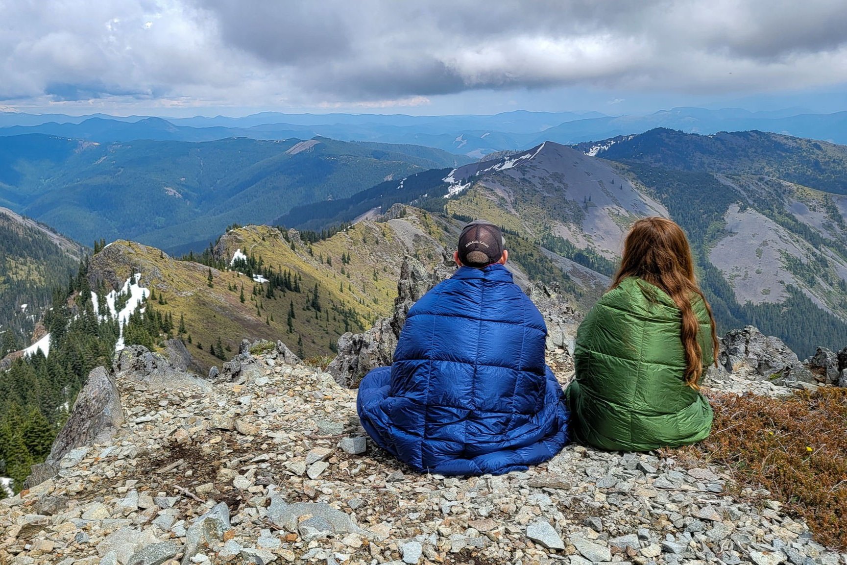 Two hikers using the Horizon Hound Trek at a mountain summit