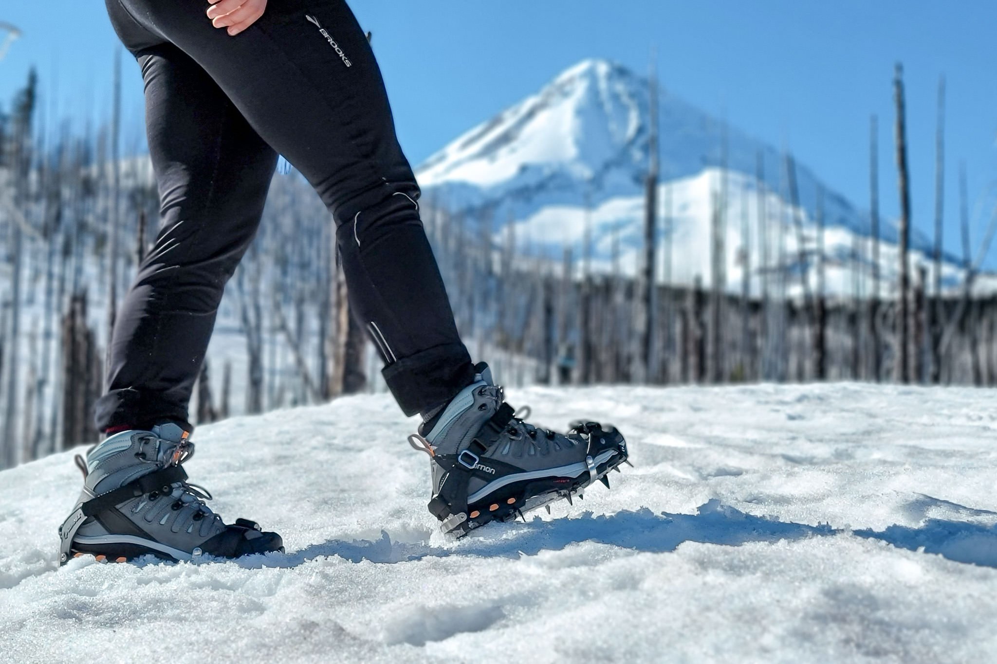 A hiker wearing the Kahtoola K-10 hiking crampons